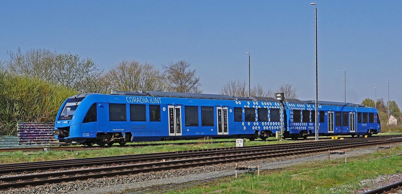 A blue Coradia iLint passenger train standing in a rail siding